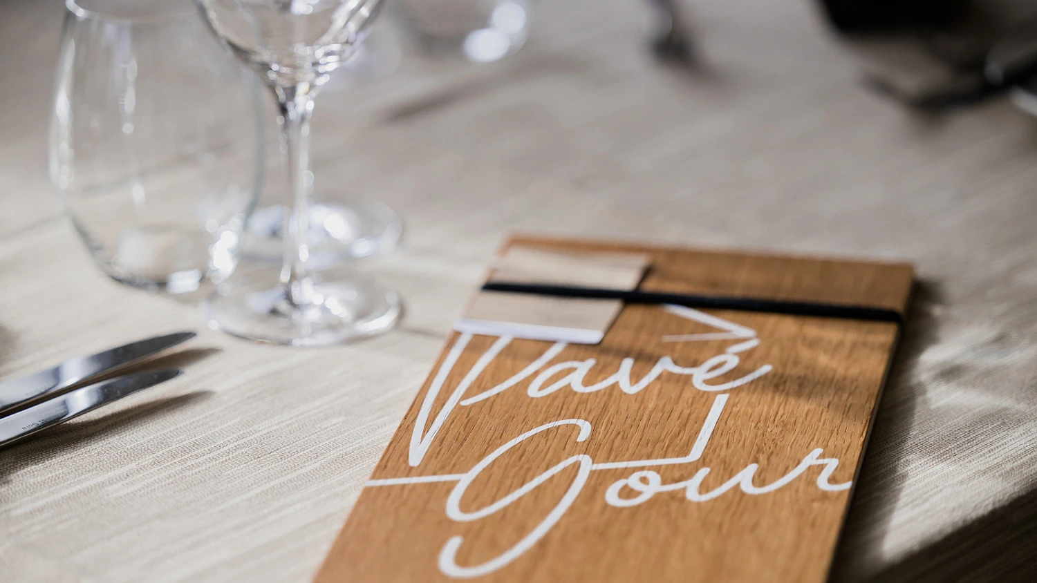 Table de restaurant bien dressée avec le logo du restaurant Le Pavé Gourmand.